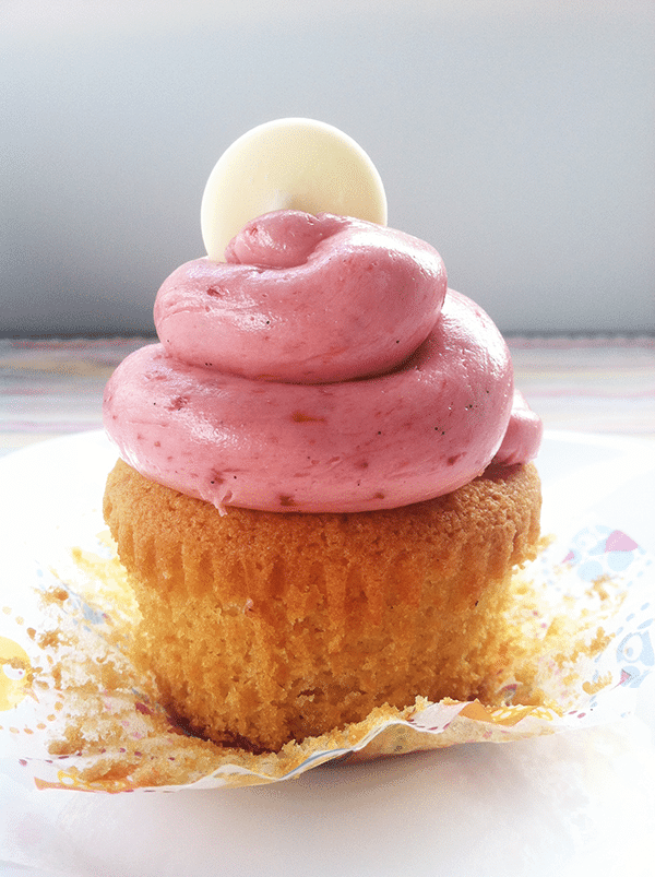 Unwrapped White Chocolate Cupcake topped with strawberry frosting