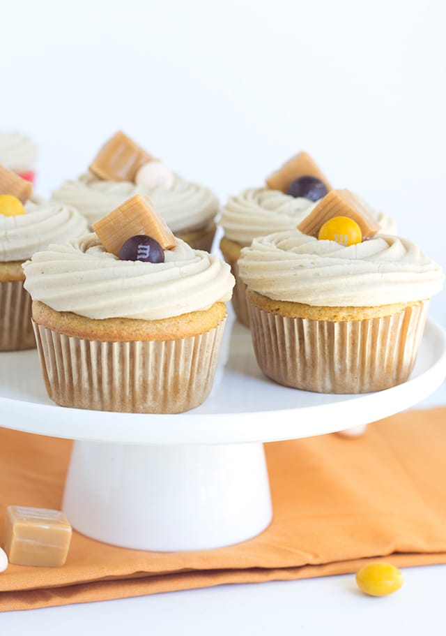 Spiced Candy Apple Cupcakes with Crunchy Caramel Frosting - A delicious cupcake filled with M&M's®, apple sauce and spices and topped with a crunchy caramel frosting!