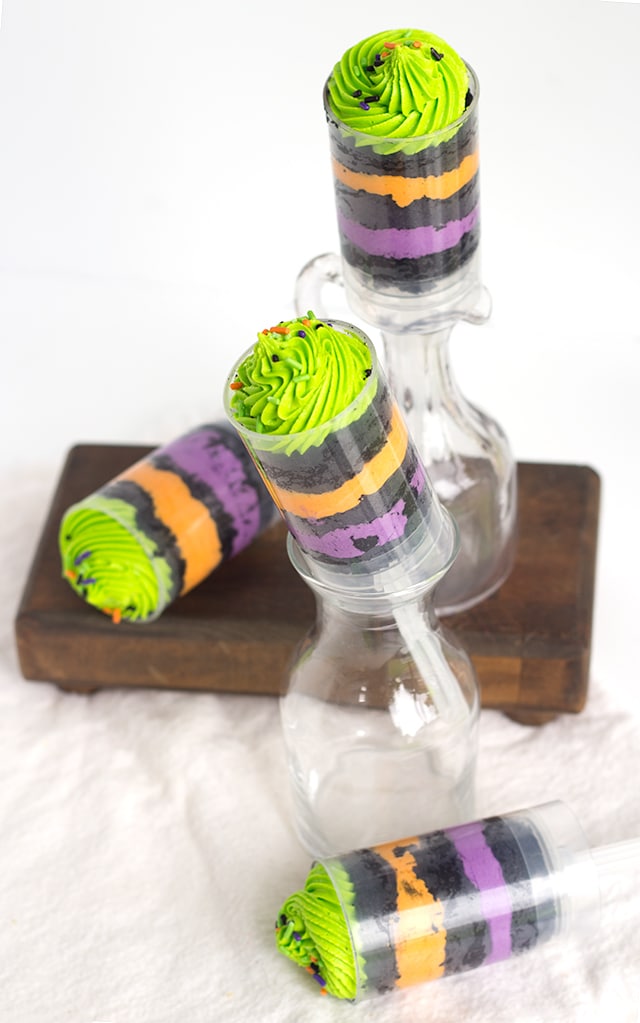 Easy Halloween Push Pops - Fun and colorful halloween colored push pops filled with vanilla frosting and vanilla cake colored black.