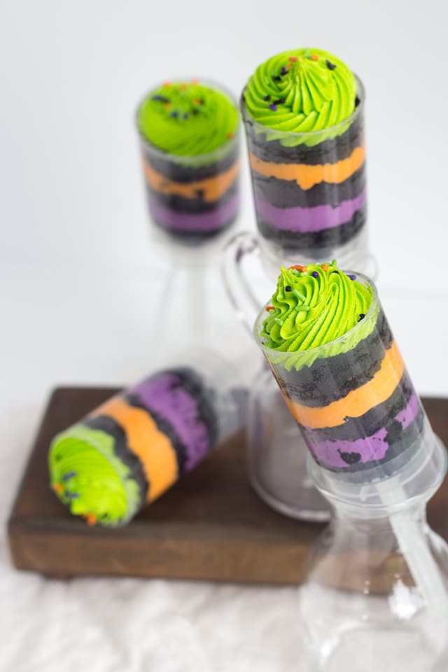 Easy Halloween Push Pops - Fun and colorful halloween colored push pops filled with vanilla frosting and vanilla cake colored black.