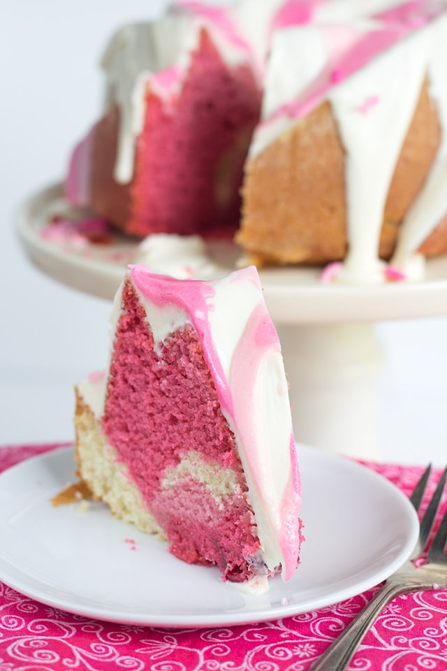 Raspberry Vanilla Pink Ombre Bundt Cake - Dense vanilla cake with a hint of raspberry flavoring and a beautiful pink ombre effect. Breast Cancer Awareness sprinkles are a necessity!