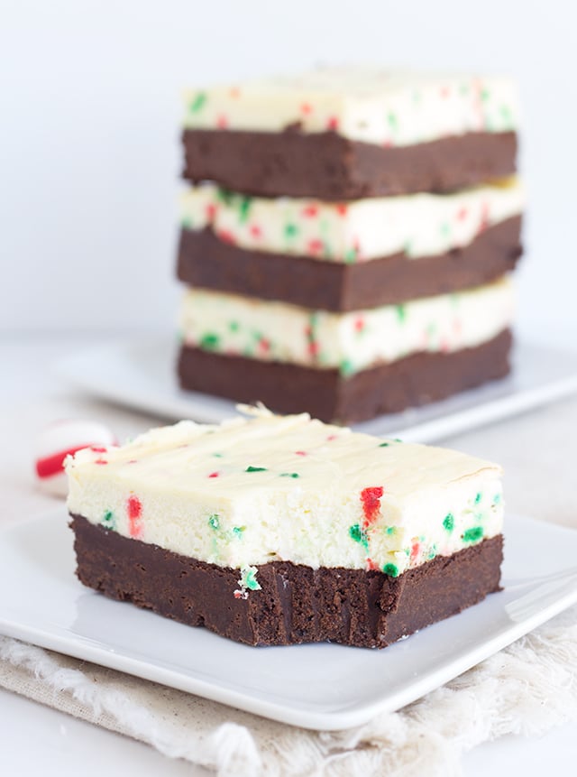 Peppermint Cheesecake Brownies - thick, fudgy dark chocolate brownies topping with a peppermint cheesecake. Throwing in some Christmas sprinkles is a must for the holidays!