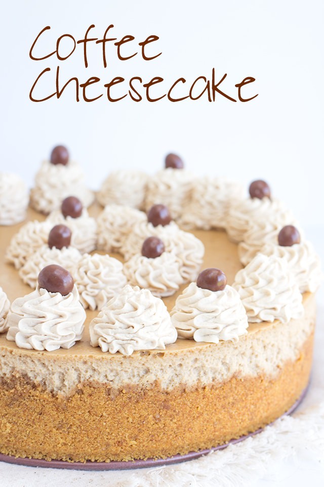 Coffee Cheesecake decorated with dollops of whipped cream and chocolate covered coffee beans