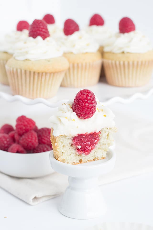 Raspberry Champagne Cupcakes - Kick off the new year with champagne cupcakes filled with a raspberry champagne filling and topped with a champagne frosting.