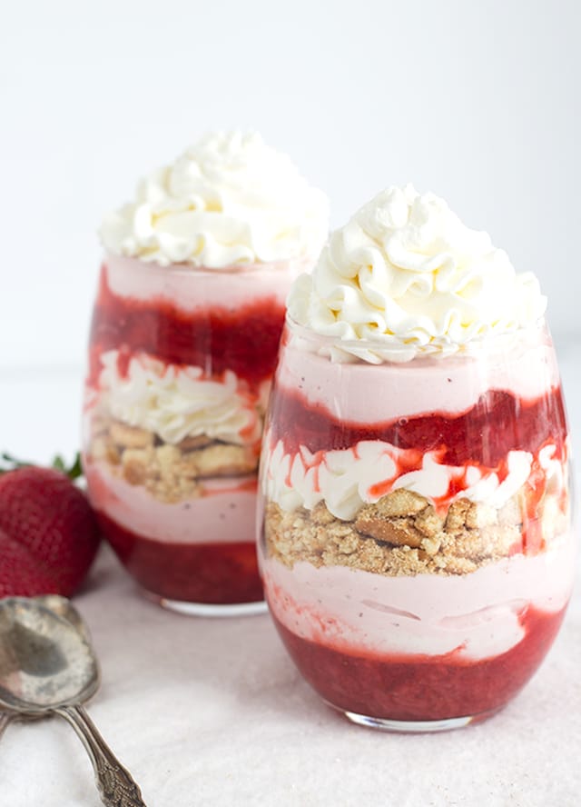 Strawberries and Cream Trifles - layers of strawberries with syrup, strawberry mousse, vanilla cookies and whipped cream. This is not only beautiful, but tastes amazing!