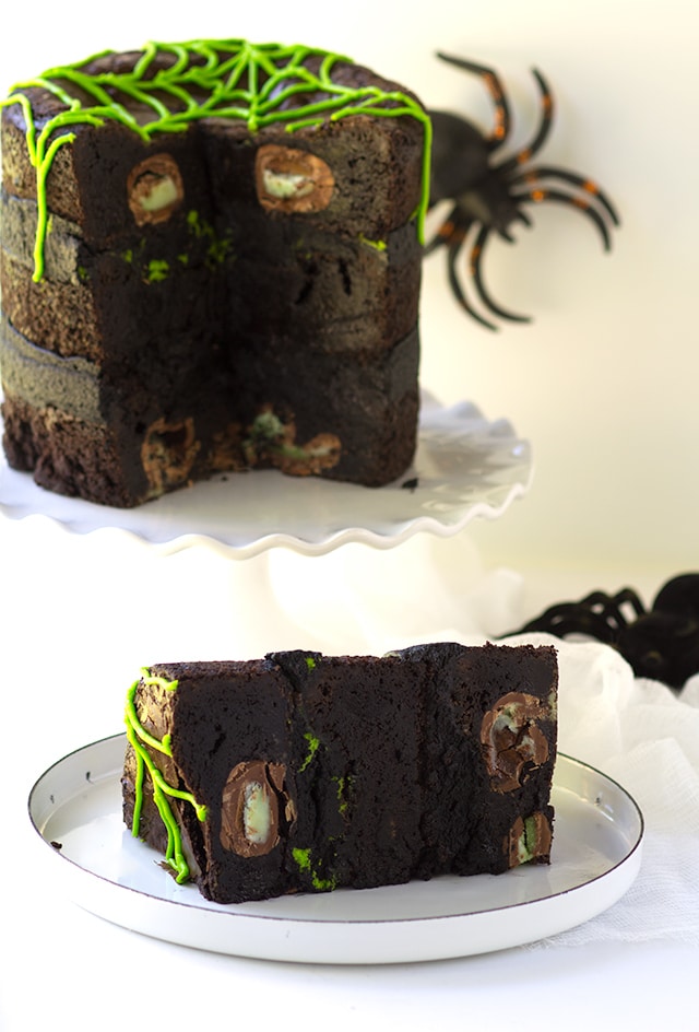 Spider Egg Brownie Cake - three layers of brownie stuffed with cadbury screme eggs (spider eggs). It's then filled with a mixture of chocolate and vanilla frosting!