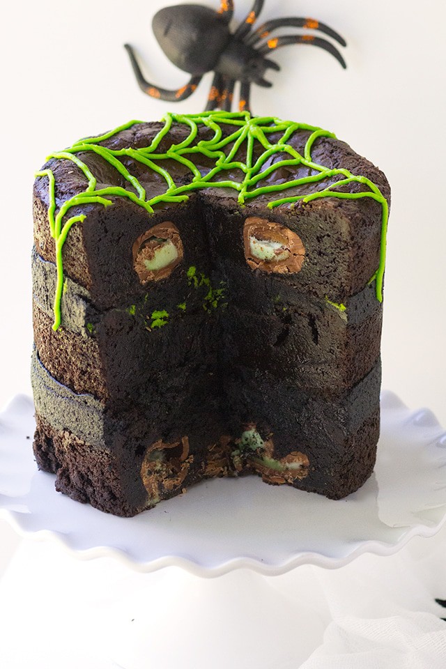 Spider Egg Brownie Cake - three layers of brownie stuffed with cadbury screme eggs (spider eggs). It's then filled with a mixture of chocolate and vanilla frosting!