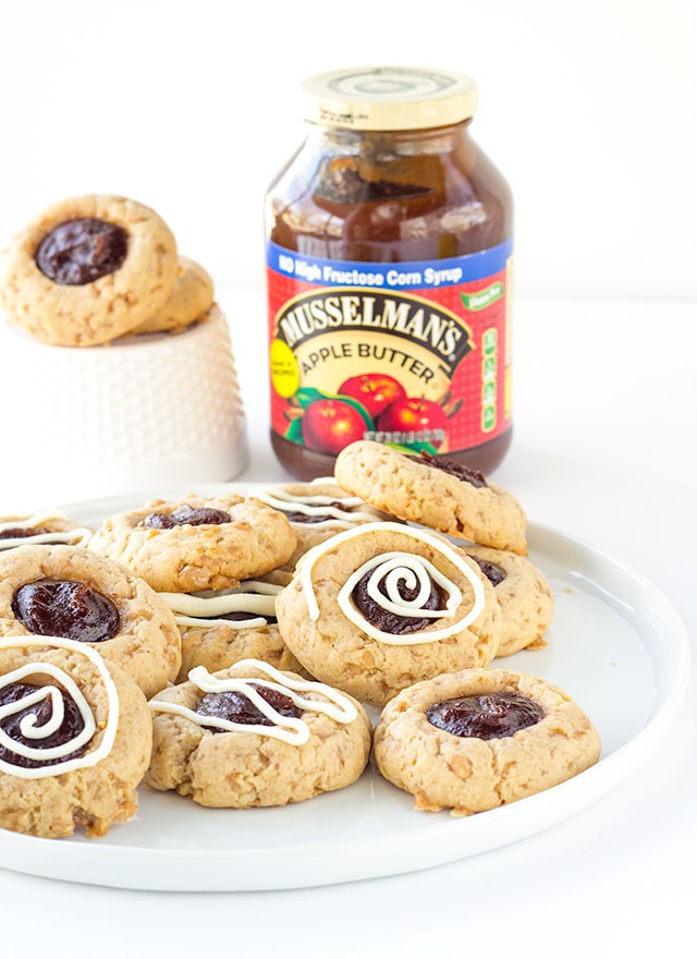 Apple Toffee Thumbprint Cookies - apple butter filled thumbprint cookies with bits of toffee in them. Don't forget the cream cheese drizzle to finish the cookies off!