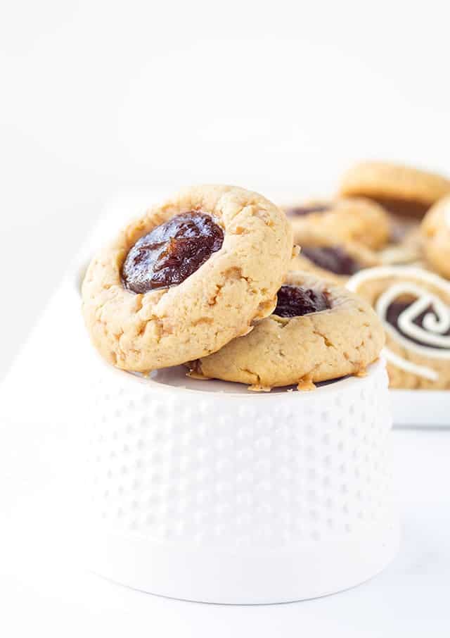 Apple Toffee Thumbprint Cookies - apple butter filled thumbprint cookies with bits of toffee in them. Don't forget the cream cheese drizzle to finish the cookies off!